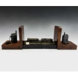 A pair of oak bookends, mid 20th century, each mounted a model of a Cornish engine house, height