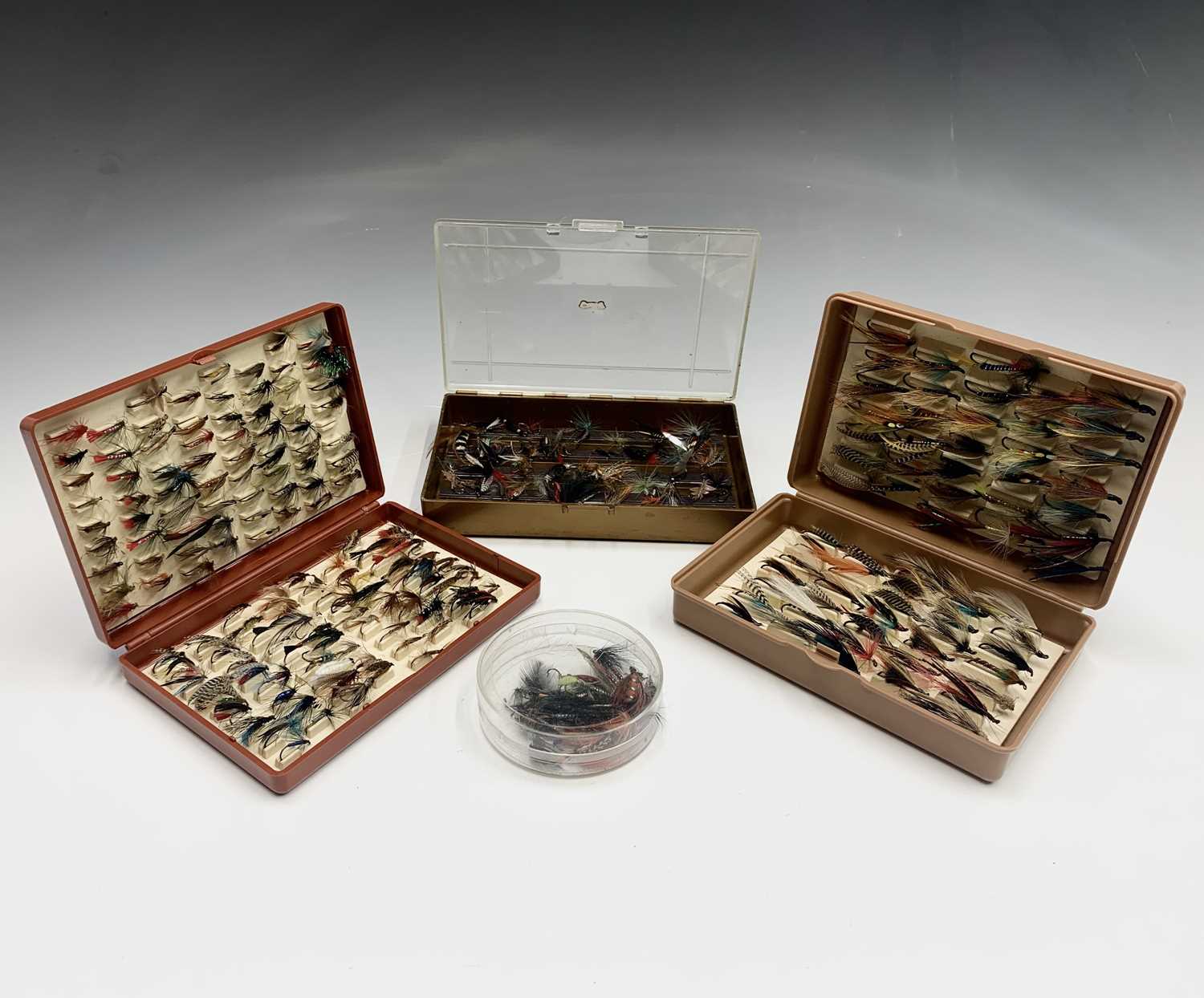 Two boxes of assorted fishing flies and a small quantity of other flies, contained in a mahogany