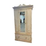 A pine wardrobe, with a single mirrored door above a single drawer, height 220cm, width 107cm, depth
