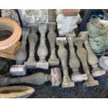 Eight composition stone balustrades. Height 74cm.