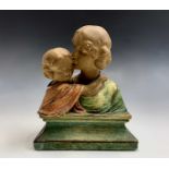 An Arts and Crafts plaster bust, modelled as a Pre Raphaelite style mother and child on a plinth