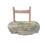 An iron boot scraper set in a granite block. Height 46cm, width 50cm, depth 31cm.