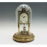 A rare German brass 400 day calendar torsion clock, circa 1910, the arched dial incorporating day