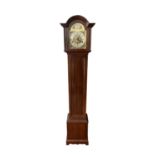 An Edwardian mahogany 'Grandmother' clock, with arched brass dial and triple train musical movement,