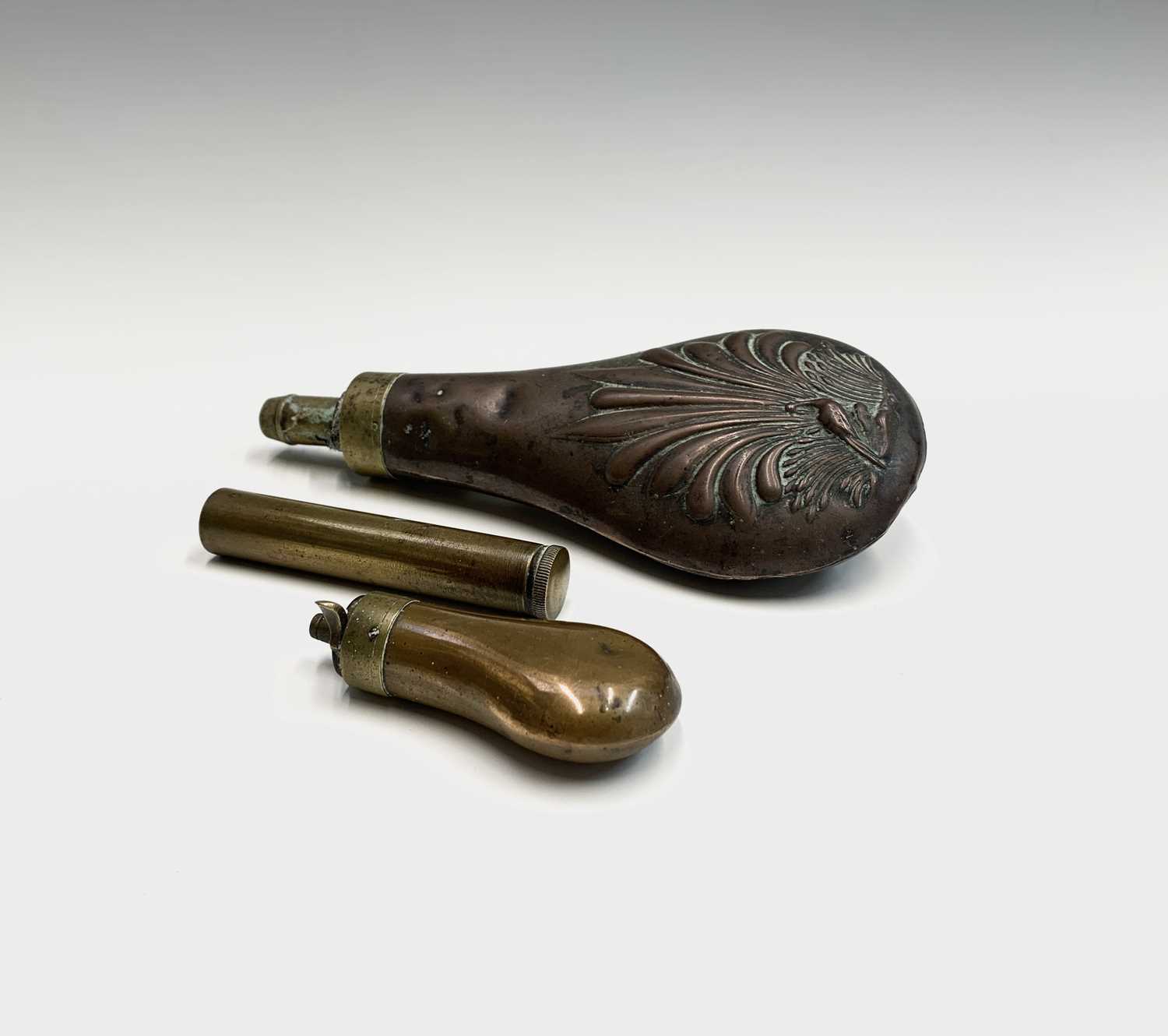A 19th century copper and brass small powder flask, length 8cm, another powder flask and a