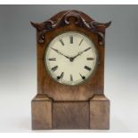 A late 19th century American figured walnut repeating mantel clock, with leaf moulded swept arch and