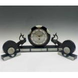 A French Art Deco three piece clock garniture, the circular dial in a green and black marble case,
