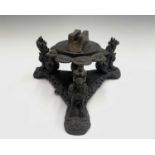 A Burmese carved hardwood stand, mounted with three temple dogs on a triform base, width 28cm,
