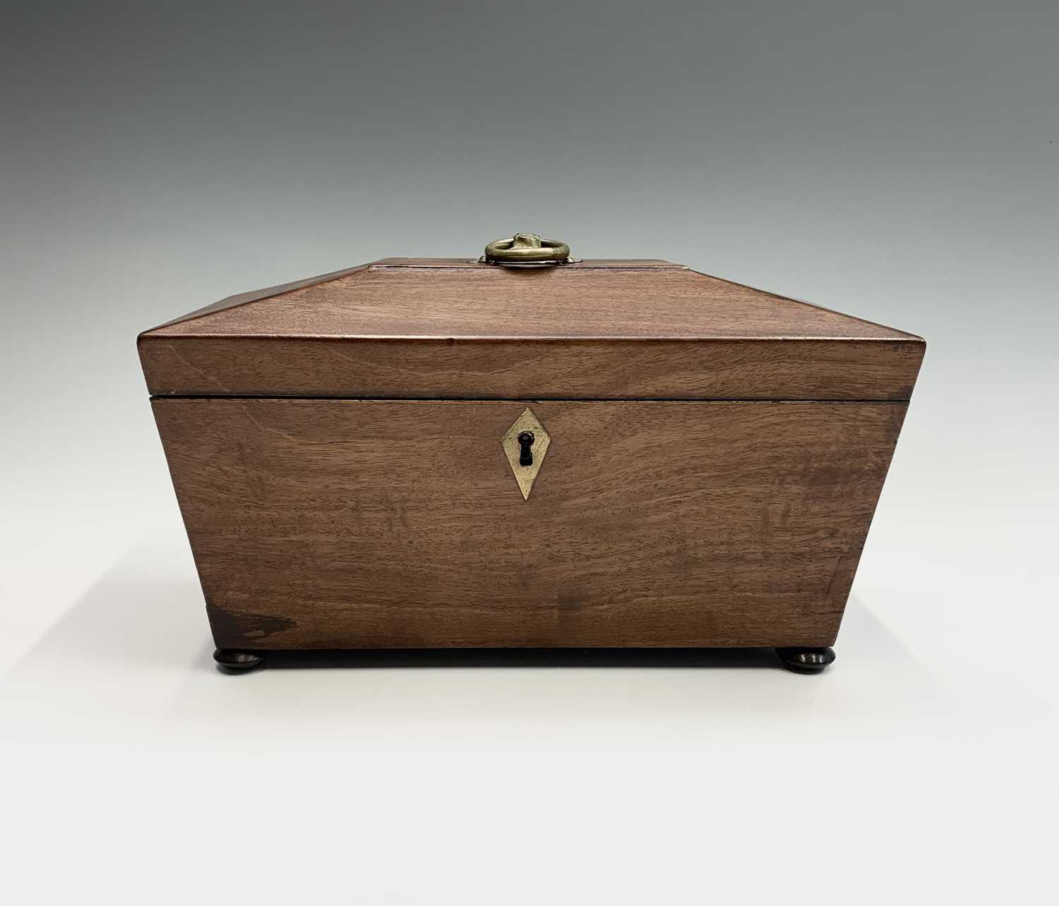 A Regency mahogany tea caddy, the interior with two lidded compartments and aperture for a mixing