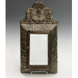 An early 20th century wall mounted key cabinet, the sheet brass having repousse floral decoration