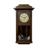 An unusual Black Forest oak cased torsion wall clock, circa 1920, the movement by Badische, with