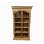 A Victorian pine cabinet, with a pair of glazed doors enclosing five shelves, height 180cm width