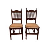 A pair of Aesthetic Movement mahogany spindle back bedroom chairs, height 95cm, width 42.5cm.