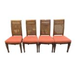 A set of four walnut dining chairs, 20th century, each with a floral decorated cartouche above a