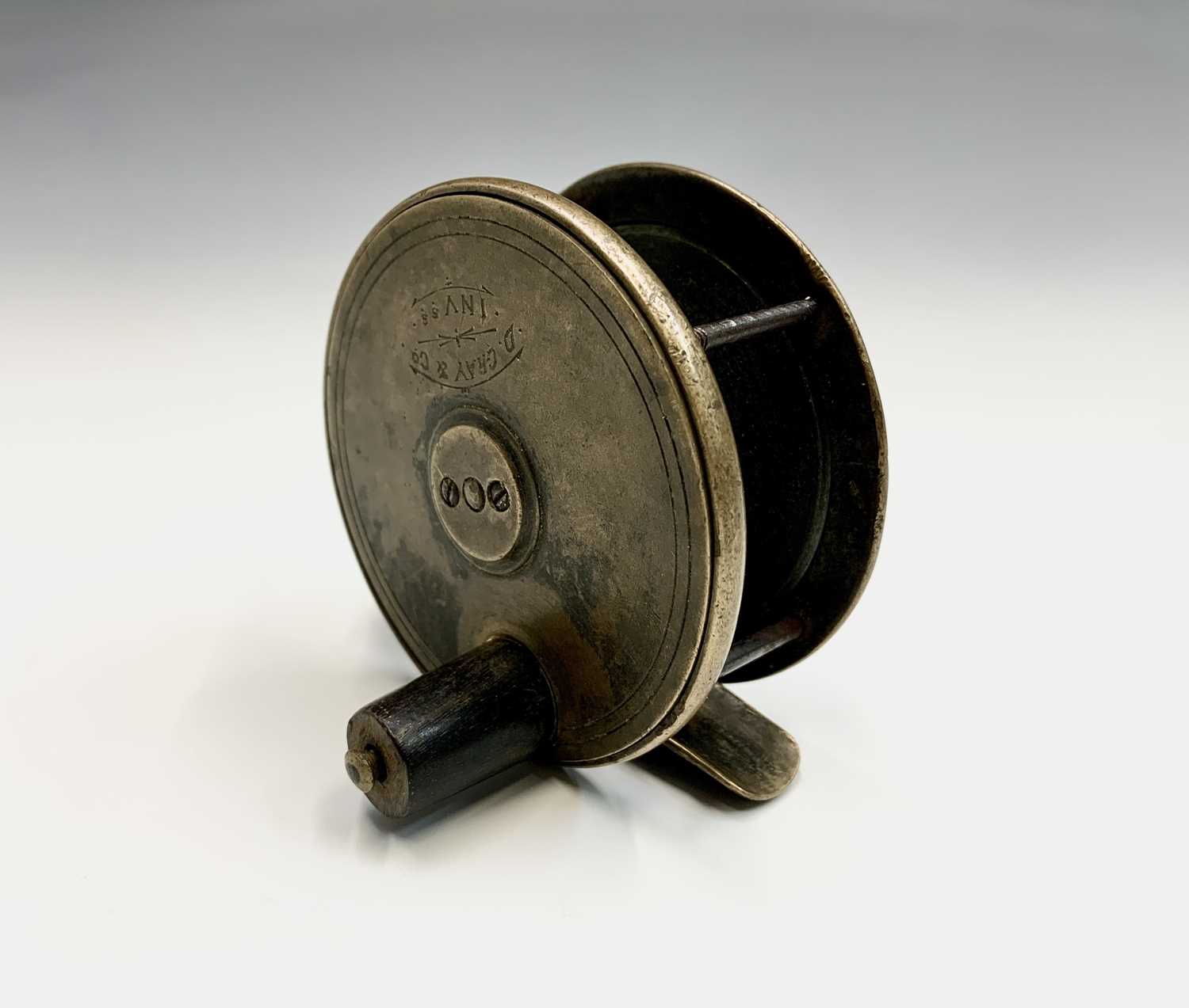 A brass fly fishing reel by D. Gray & Co, Inverness, diameter 7cm.