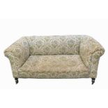 A Victorian mahogany upholstered Chesterfield, with turned tapering front legs, height 67cm, width
