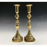 A pair of early 20th century brass candlesticks. Height 30.5cm.
