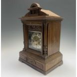 A German Junghans musical walnut mantle clock, circa 1900, the case with twin columns and Art