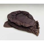 A late 18th century brown silk Calash bonnet, having four ruched sections terminating in a flat rear