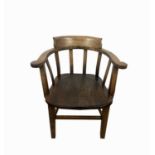 A 20th century beech and elm Captain's armchair, height 76cm, width 62cm.