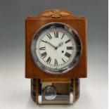 A Continental Art Deco walnut thirty hour wall clock with white enamel dial and glazed pendulum