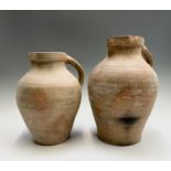 Two late 19th/early 20th century earthenware jugs. Heights 38.5cm and 33cm.
