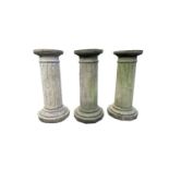 Three reconstituted stone fluted columns. Height 52cm.