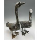 A pair of metal geese garden ornaments. The tallest 73cm high.