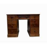 A Victorian mahogany pedestal desk, the rectangular moulded top above an arrangement of nine