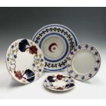 Three sponged and painted pottery plates and a dish, probably Welsh, with central star and