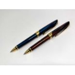 Two Parker Ellipse ballpoint pens, one red and the other blue, each with Q date code, each with blue