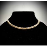 A contemporary 18ct two-colour gold weave design necklace 25.6gm