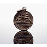 A Nelson's Flagship Foudroyant souvenir fob and another for HMS Victory