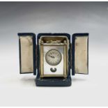 A French miniature alarm clock, with dummy pendulum bob, viewed through a lenticle cut in the mother