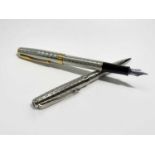 A Parker Sonnet silver Fougere fountain pen with 18ct medium nib and gold trim date IIE and a