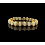An 18 ct gold bracelet with twenty opals, each divided by a pair of diamonds 21.8gmCondition report: