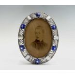 An Ella Naper (1886-1972) enamelled silver and mother of pearl oval frame, the broad border has