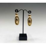 A pair of Victorian high purity plain gold earrings each with a double oval in which hangs a pendant