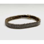 A 9ct gold bracelet set with over 200 small diamonds arranged in 73 links each with a diagonal of