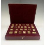 A set of 25 silver gilt replica stamps.