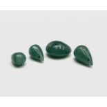 Three unmounted jade teardrops and a jade bead 6.7gm