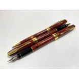 A Parker Sonnet Chinese three pen red set with Chinese inscriptions in gold the fountain pen with