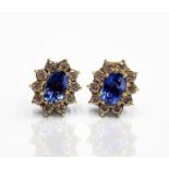 A pair of good oval pale sapphire and diamond cluster earrings, maximum size of each cluster 12.7