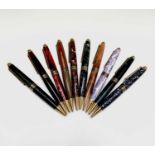 Ten ballpoint pens, each has gold plated mounts and a variety of tubes in wood and acrylic, each