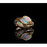 A 9ct gold contemporary ring set with three navette opals and small diamonds 4gm