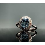 An 18ct white gold and platinum ring set an oval aquamarine of approximately 2cts within a lobed