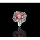 A rare and valuable 3.16ct pink diamond ring, the emerald cut stone set in platinum within a