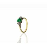 An 18ct gold ring set an emerald and two bright diamonds 2.7gmCondition report: Size N - N1/2,