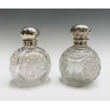 Two large spherical glass toilet bottles each with silver lid