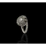 A white gold or platinum ring with a circular diamond cluster totalling just over 1ct 4.4gm